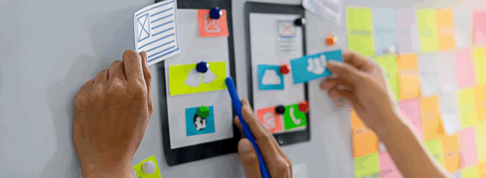 prototyping a web page on a white board with cut outs